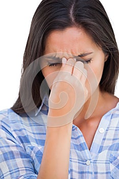 Brunette wincing with headache pain photo