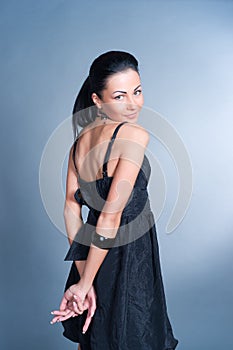 Brunette woman against blue background.