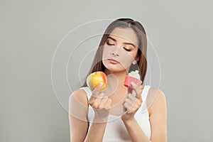 Brunette Woman with Apple Fruit and Sweets. Weight Loss, Diet, Healthy Food and Dieting concept