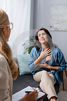 Brunette woman appreciating help of therapist