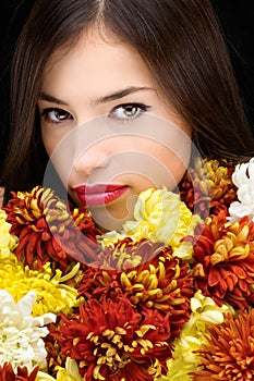 Brunette woman behind flowers