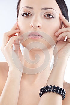 Brunette woman with black pearl bracelet on hand