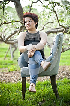 Brunette Woman on a Chair Outside