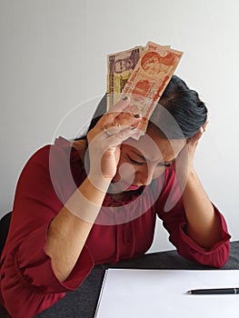 brunette woman with expression of despair and grabbing Honduran money