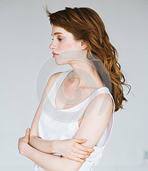 Brunette Woman girl with long and shiny wavy curly hair.