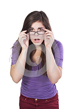 Brunette woman in glasses peering in amazement