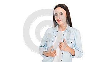 Brunette woman with hands on denim jacket isolated on white