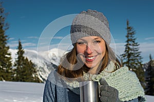 Brunette woman hoding thermos photo