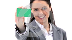 Brunette woman holding a business card