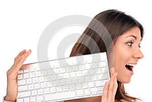 Brunette woman holds wireless computer keyboard