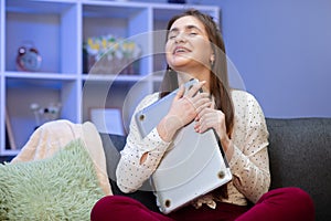 Brunette woman hug laptop computer, she love her work. Happy young girl,student hugging book, notebook, love studying