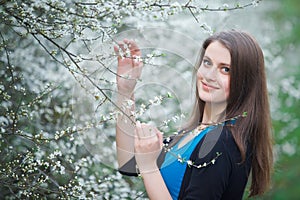 Brunette woman inhales the scent of flowers