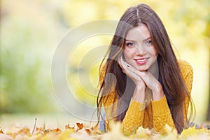 Brunette woman laying in autumn park