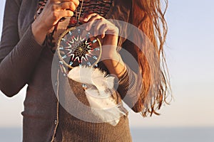 Brunette woman with long hair holding dream catcher