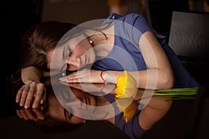 brunette woman looking her reflection in a mirror