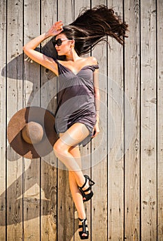 Brunette woman lounging on sundeck