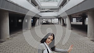 Brunette woman is performing modern dance, posing, twisting rotating, urban contemporary freestyle