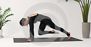 Brunette woman practicing yoga, performing Chaturanga Dandasana exercise, dynamic plank