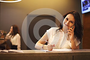 Brunette woman receptionist working in Reception