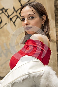 Brunette woman in red blouse and faux fur