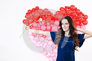 brunette woman with red heart balloons and flowers