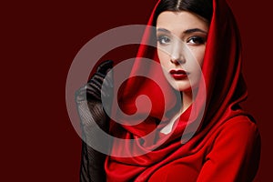 brunette woman with red lips and veil over her head