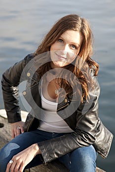 Brunette woman on riverbank