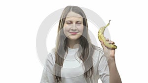 Brunette woman showing banana