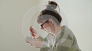 brunette woman sitting on the floor and eating noodles on stools, economic crisis, cheap food