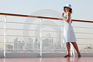 Brunette woman standing on cruise liner deck