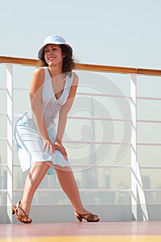 Brunette woman standing on cruise liner deck