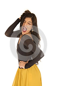 Brunette woman standing posing with a funny expression her mouth