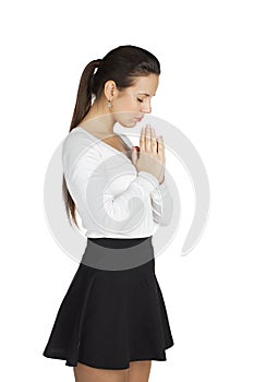 Brunette woman standing for white background with her hands fold