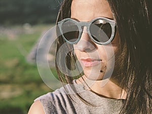 Brunette woman with sunglasses in a close up portrait