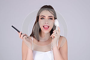 Brunette woman talking on retro line phone. Portrait of woman holding vintage telephone. Pin up girl with phone handset