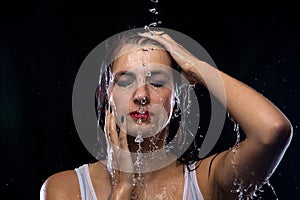 Brunette woman under running water