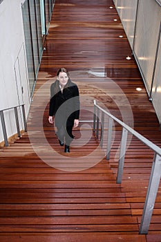 Brunette Woman Walking Up Stairs