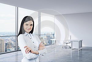 A brunette woman in a workplace at modern corner panoramic office in New York, Manhattan. A concept of financial consulti