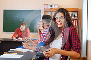 Brunette Young Girl Hold Cell Smart Phone Looking Camera, Mixed Race Students Group
