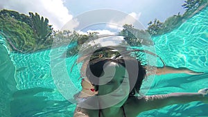 Brunette young happy woman swimming underwater in pool. 1920x1080