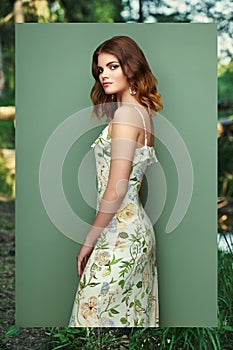 Brunette young woman in floral spring summer dress