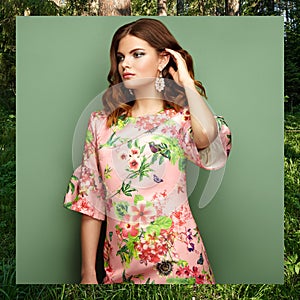 Brunette young woman in floral spring summer dress