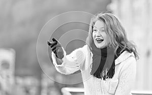 Attractive lady in white knitted coat and scurf. woman exited welcome on street. photo