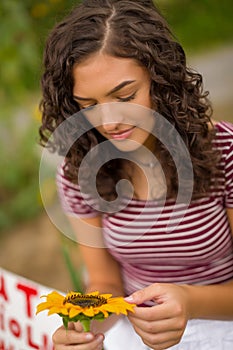 Brunetter high school senior girl with sunflower