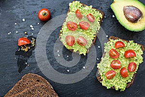 Bruschetta with avocado, cherry tomatoes and spices