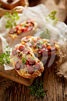 Bruschetta with cheese and sausage sprinkled with herbs