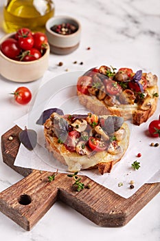 Bruschetta with ciabatta bread, mozzarella cheese, champignon mushrooms and cherry tomatoes