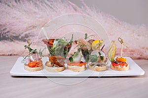 Bruschetta with different sensations on a white plate.