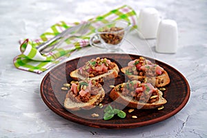 Bruschetta with duck confit pate, apple chutney and caramelized pumpkin seeds