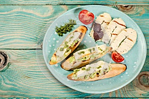 Bruschetta with grilled cheese halumi on a wooden background. Preparation of cheese Halumi. Cheese Halumi with mint